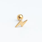 Piercing dorado en forma de rayito