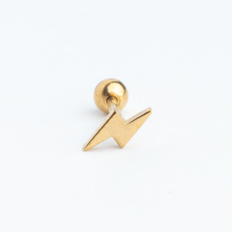 Piercing dorado en forma de rayito