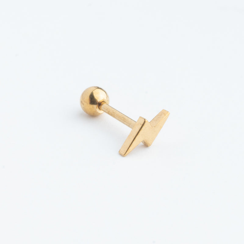Piercing dorado en forma de rayito